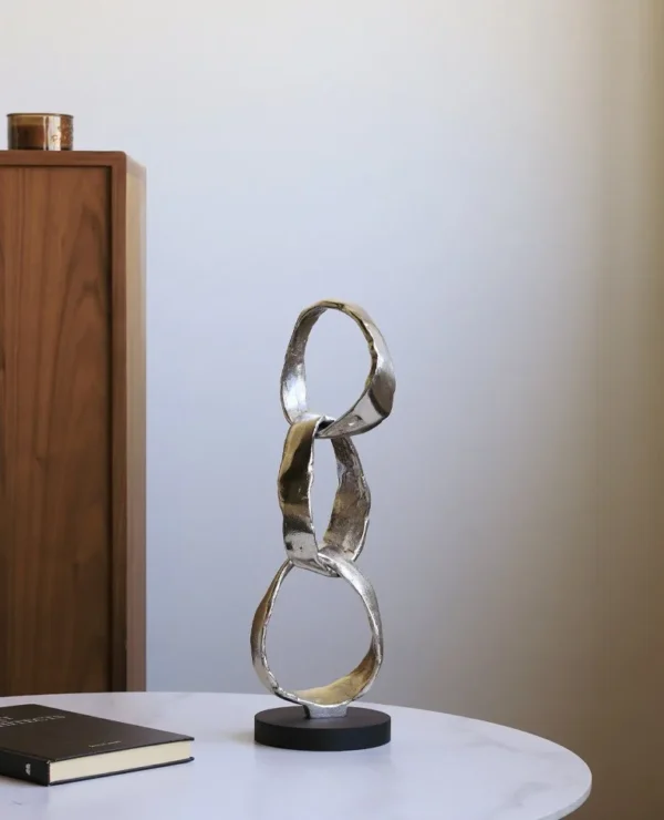 Imported Aluminium Ring Sculptures on Black Base, Two Forms in silver — in a room setting