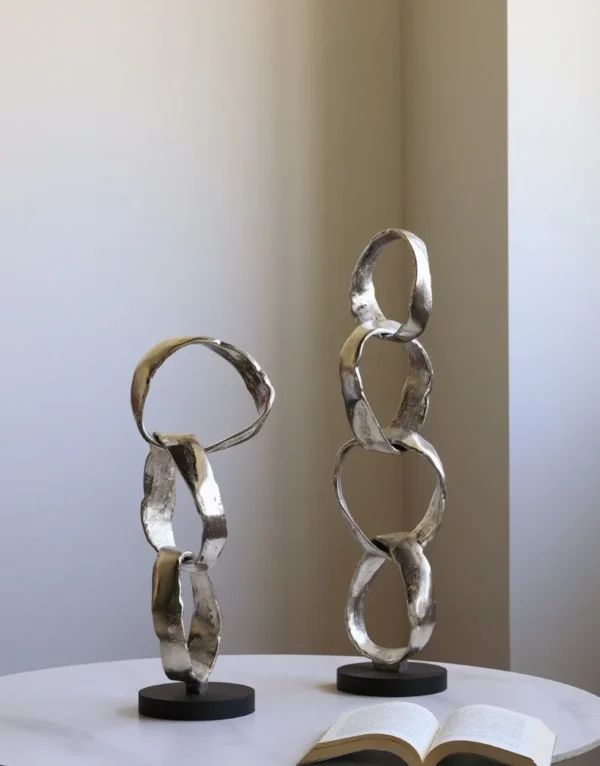 Imported Aluminium Ring Sculptures on Black Base, Two Forms in silver — in a room setting