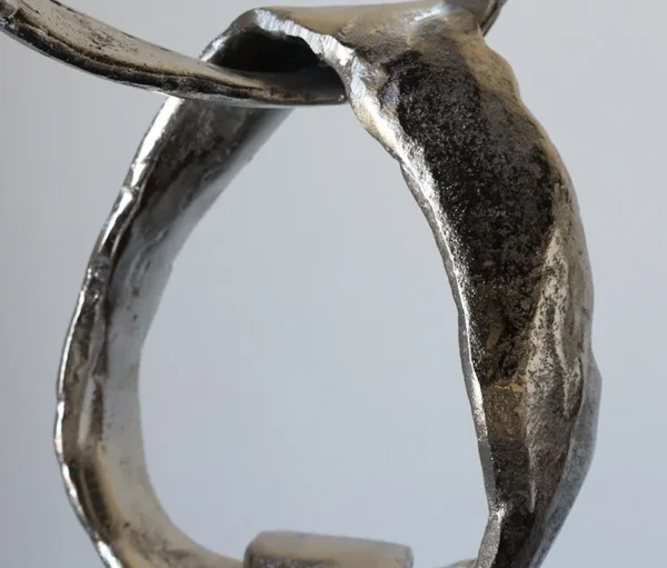 Imported Aluminium Ring Sculptures on Black Base, Two Forms in silver — in a room setting