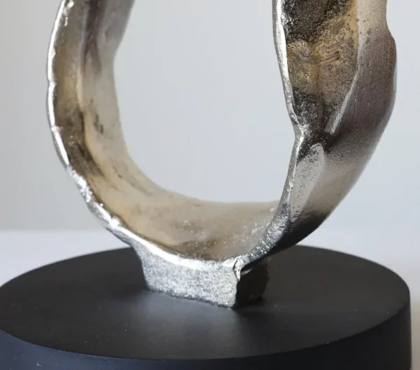 Imported Aluminium Ring Sculptures on Black Base, Two Forms in silver — in a room setting