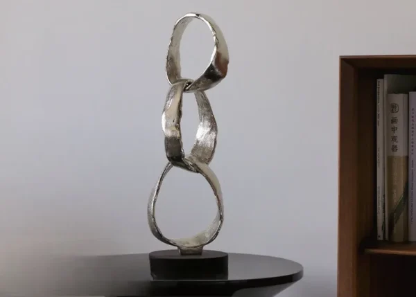 Imported Aluminium Ring Sculptures on Black Base, Two Forms in silver — in a room setting