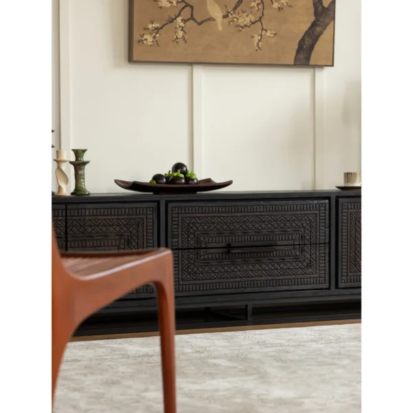 Hena Teak TV Cabinet with Hand-Carved Doors and Drawers in black — in a room setting
