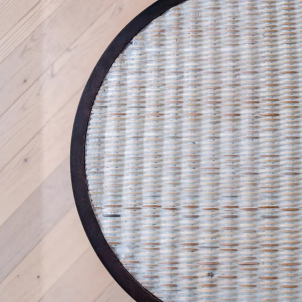 Imprint Hand-Carved Solid Wood Side Table with Woven Top in clay — in a room setting