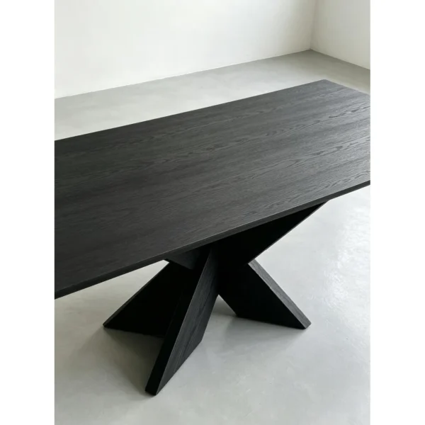Ink-Dyed Carbonised Ash Dining Table with X Base in black — in a room setting