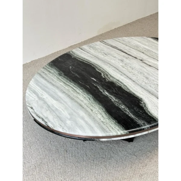 Round Panda White Marble Coffee Table in ivory — in a room setting