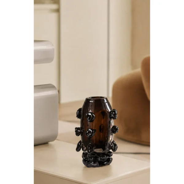 Hand-Made Amber Glass Vase with Black Studs in clay — in a room setting