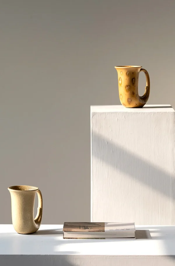 Hand-Made Speckled Ochre Ewer Vase in mustard — in a room setting