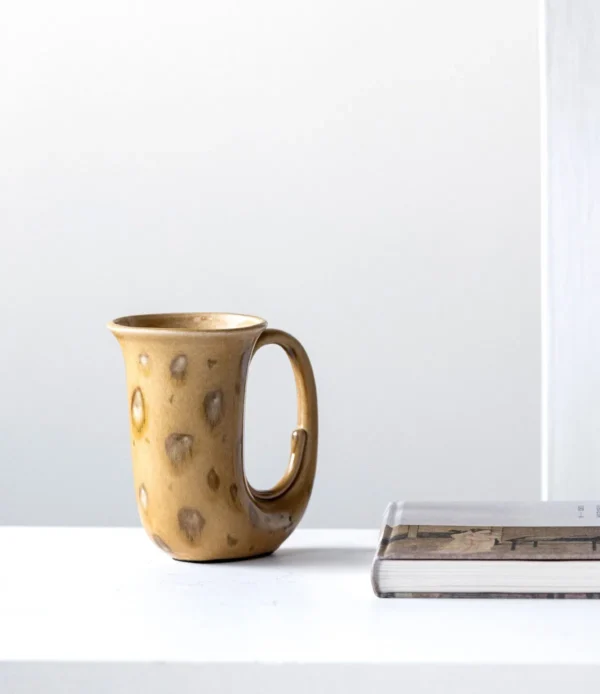 Hand-Made Speckled Ochre Ewer Vase in mustard — in a room setting