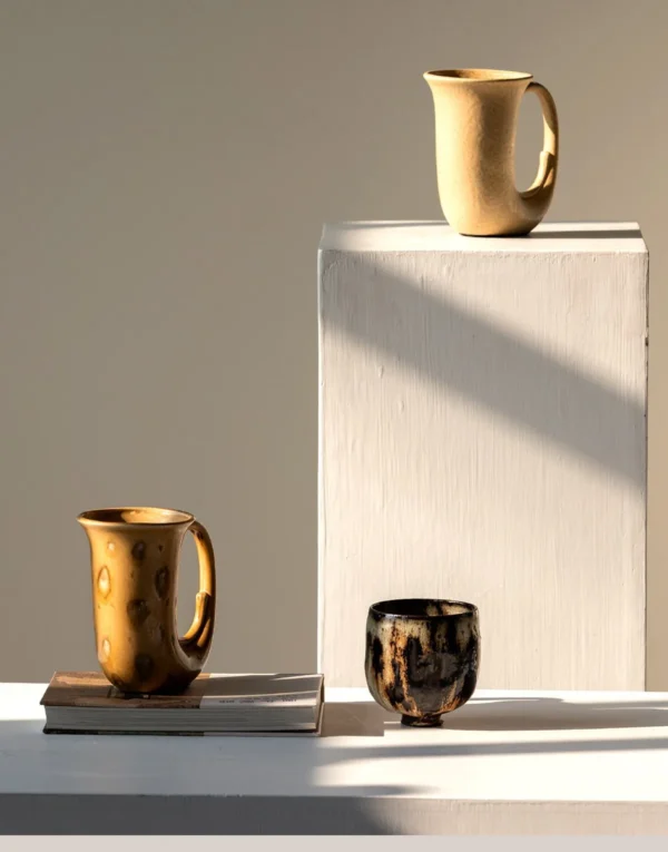 Hand-Made Speckled Ochre Ewer Vase in mustard — in a room setting