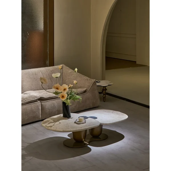 Symbiotic Two-Lobe Travertine Coffee Table, 142 cm in oatmeal — in a room setting