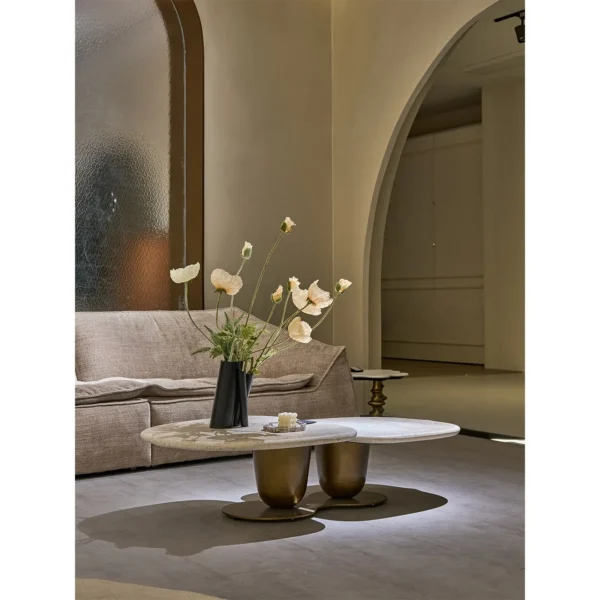 Symbiotic Two-Lobe Travertine Coffee Table, 142 cm in oatmeal — in a room setting