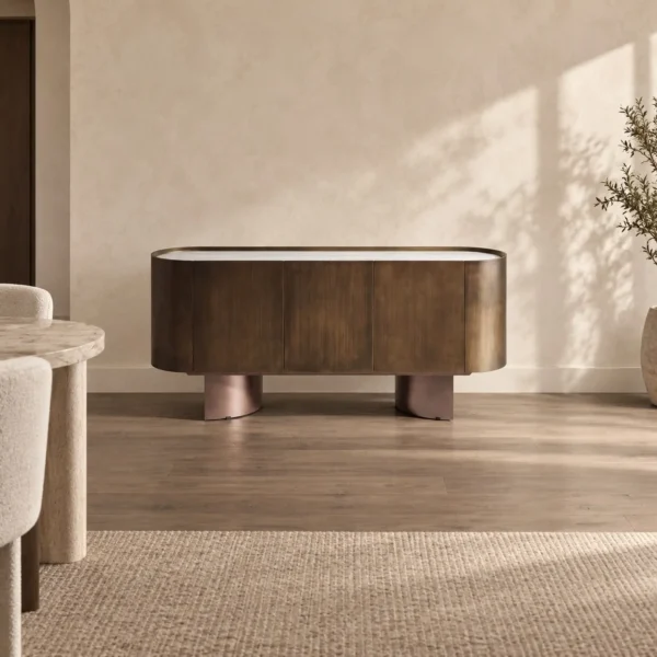 Brushed Bronze Oval Sideboard with Stone Top in bronze — in a room setting