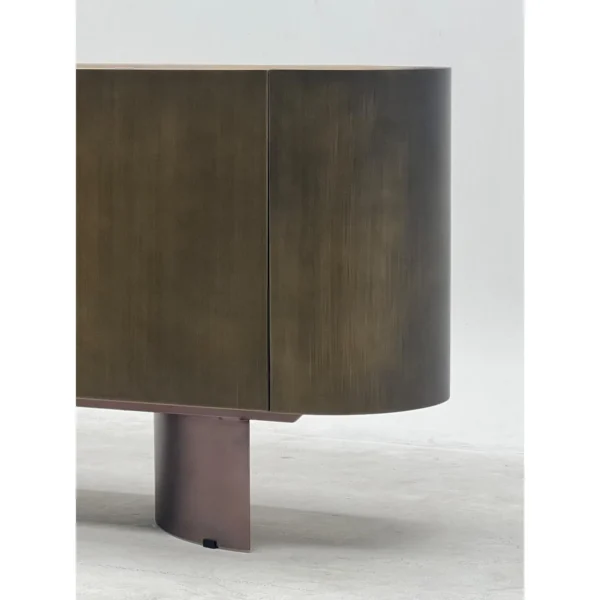 Brushed Bronze Oval Sideboard with Stone Top in bronze — in a room setting