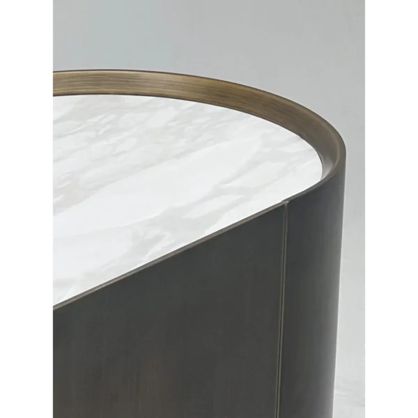 Brushed Bronze Oval Sideboard with Stone Top in bronze — in a room setting