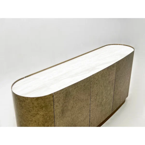 Mottled Stone-Finish Rounded Sideboard on Brass Plinth in sand — in a room setting