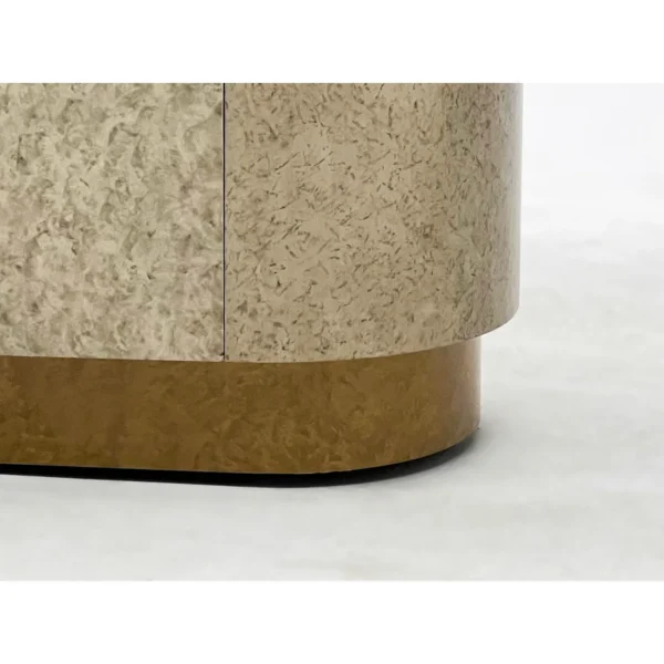 Mottled Stone-Finish Rounded Sideboard on Brass Plinth in sand — in a room setting