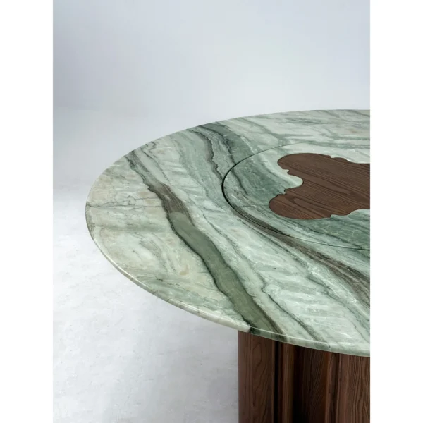 Green Stone Round Dining Table on Bent-Wood Wave Base in olive — in a room setting