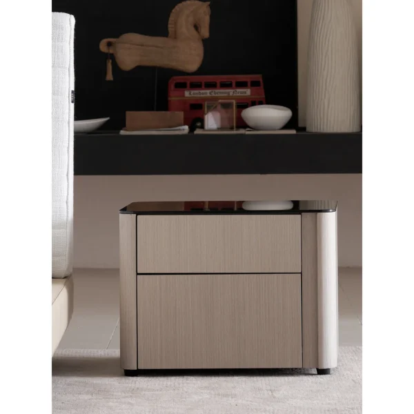 Rounded Oak Nightstand with Black Glass Top in natural oak — in a room setting