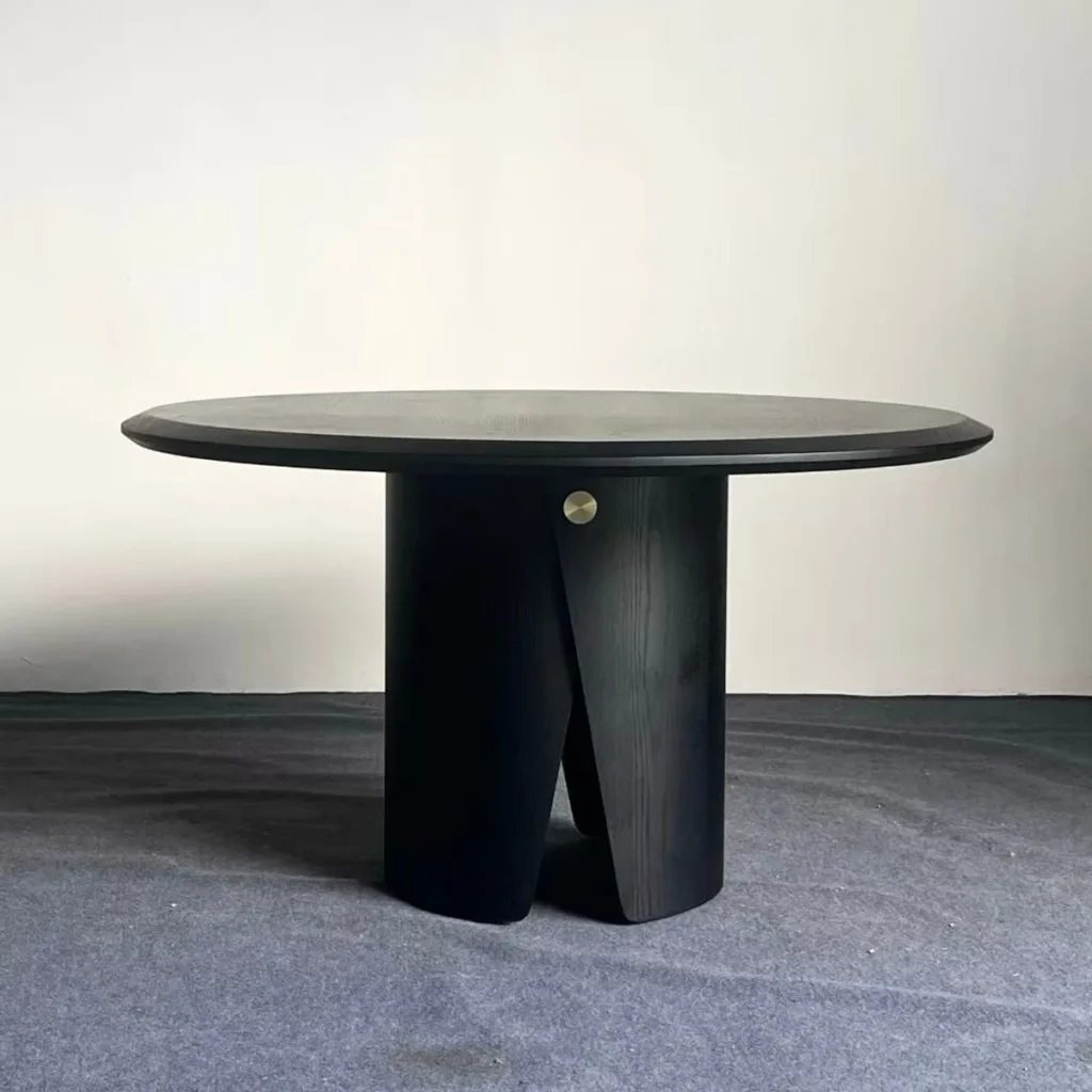 Black Round Dining Table on Sculpted Split Pedestal in black — front view