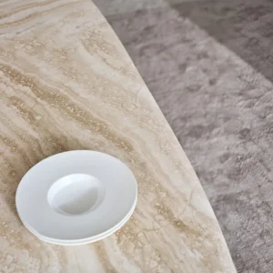 Jade Rabbit Travertine Oval Dining Table on Black Wood Legs in oatmeal — front view