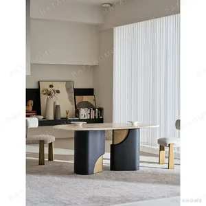Jade Rabbit Travertine Oval Dining Table on Black Wood Legs in oatmeal — in a room setting