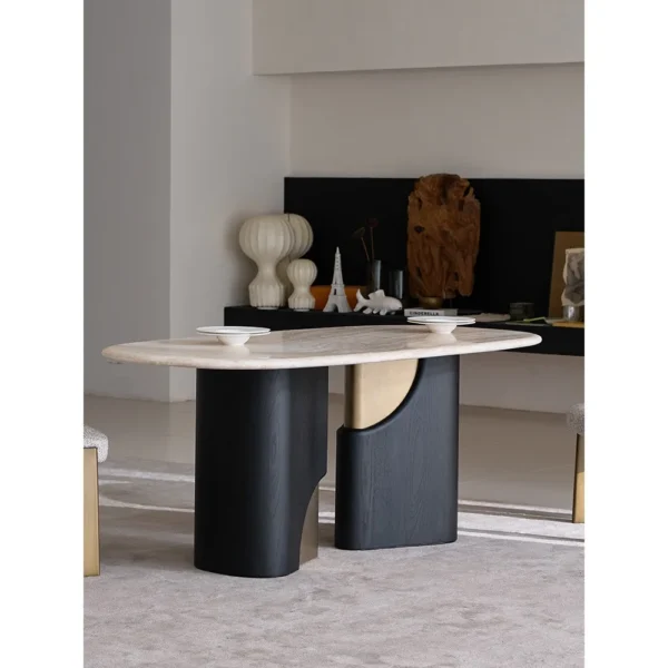 Jade Rabbit Travertine Oval Dining Table on Black Wood Legs in oatmeal — in a room setting