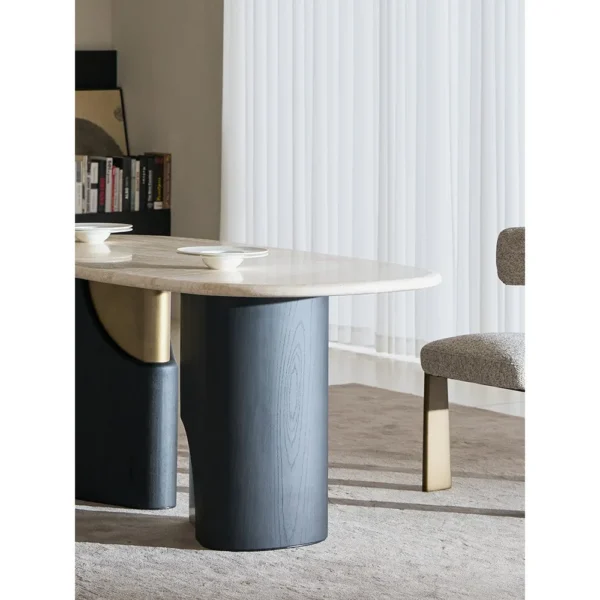 Jade Rabbit Travertine Oval Dining Table on Black Wood Legs in oatmeal — in a room setting