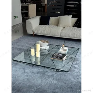 Iron Ridge Glass Coffee Table on Crossed Black Frame, 120 cm in black — in a room setting