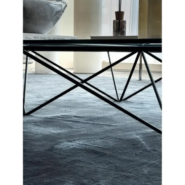 Iron Ridge Glass Coffee Table on Crossed Black Frame, 120 cm in black — in a room setting