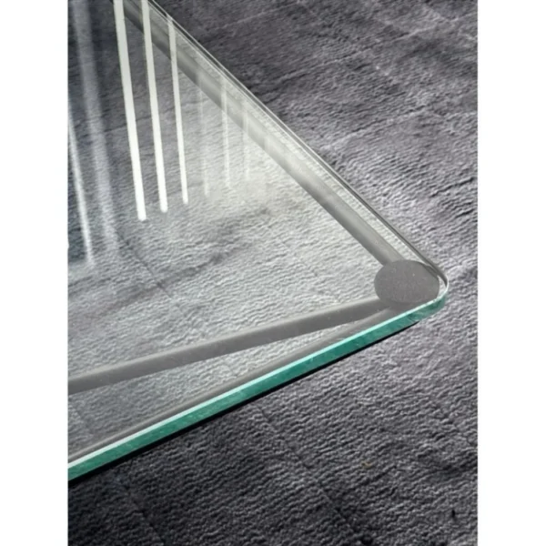 Iron Ridge Glass Coffee Table on Crossed Black Frame, 120 cm in black — in a room setting