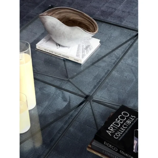 Iron Ridge Glass Coffee Table on Crossed Black Frame, 120 cm in black — in a room setting