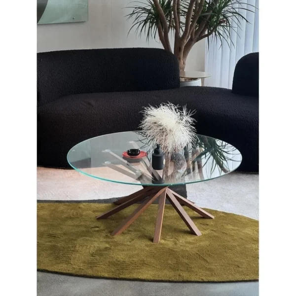 Star Round Glass Coffee Table on Splayed Wood Base, 100 cm in clay — in a room setting