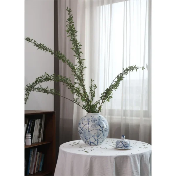 Hand-Painted Blue and White Orchid Round Jar in blue — in a room setting