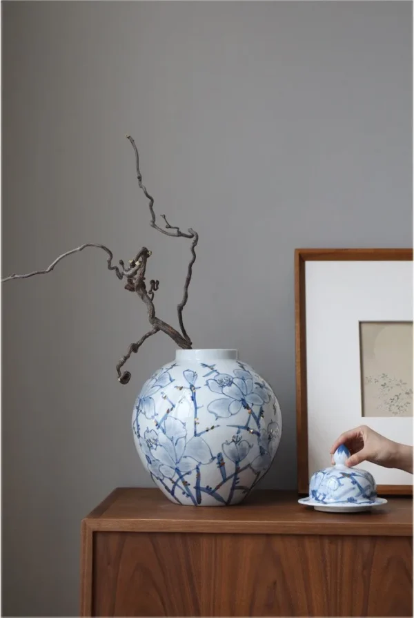 Hand-Painted Blue and White Orchid Round Jar in blue — in a room setting