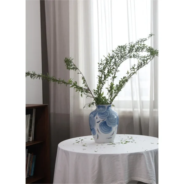 Hand-Painted Blue Wave Flat-Base Jar with Gold Fish, Large in blue — in a room setting