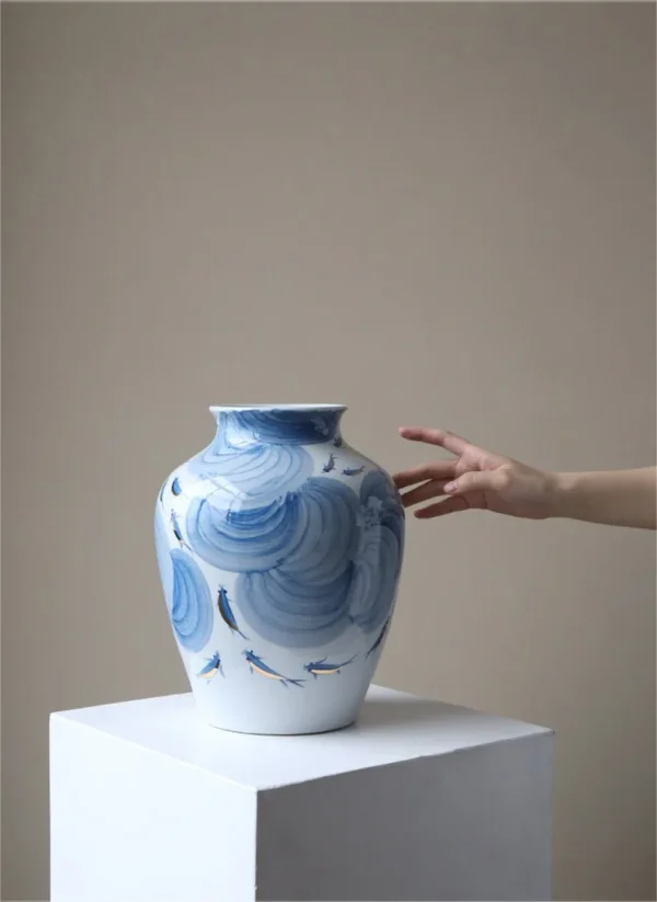 Hand-Painted Blue Wave Flat-Base Jar with Gold Fish, Large in blue — in a room setting