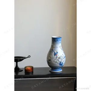 Hand-Painted Blue and White Porcelain Vase with Gilt Detail in blue — in a room setting