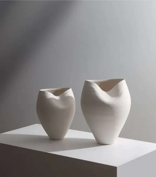 Jingdezhen White Round-Belly Ceramic Vase with Pinched Rim in ivory — in a room setting