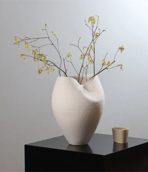 Jingdezhen White Round-Belly Ceramic Vase with Pinched Rim in ivory — in a room setting