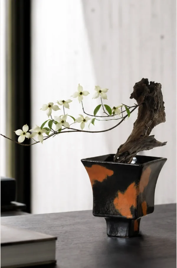 Kiln-Change Splash Glaze Square Stoneware Vase in black — in a room setting
