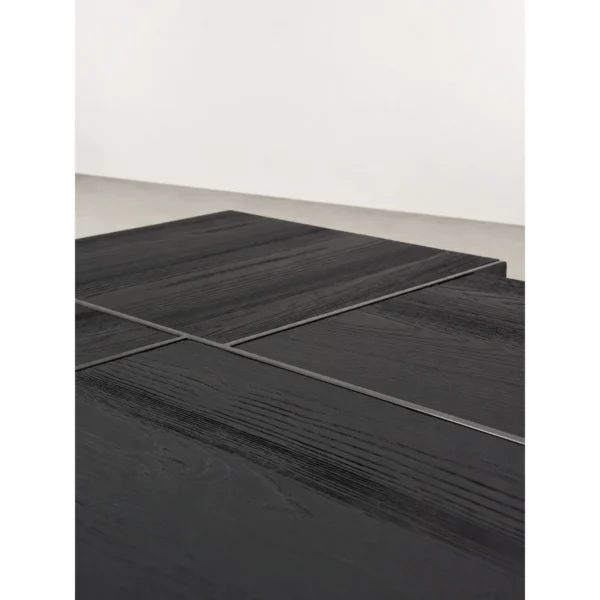 Kitale Black Oak Block Coffee Table with Black Metal Base in black — in a room setting