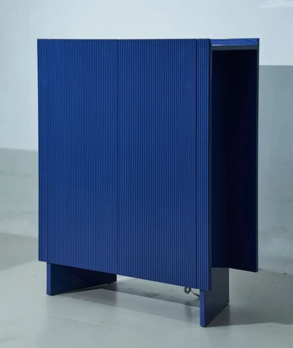 Klein Blue Fluted Lacquered Tall Cabinet in blue — in a room setting
