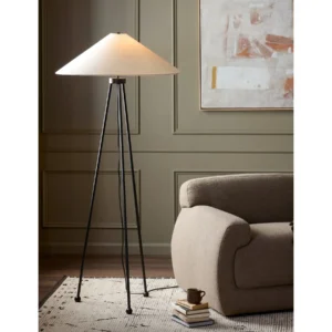 Kolbeck Black Iron Tripod Floor Lamp with Pale Cone Shade in black — in a room setting