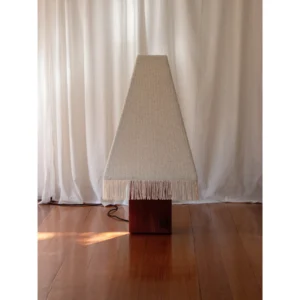 Kukeri Wood Base Floor Lamp with Fringed Pyramid Shade in oatmeal — in a room setting