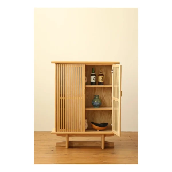 Lan Solid Wood Slatted Bar Cabinet for Whisky and Cigars in natural oak — in a room setting