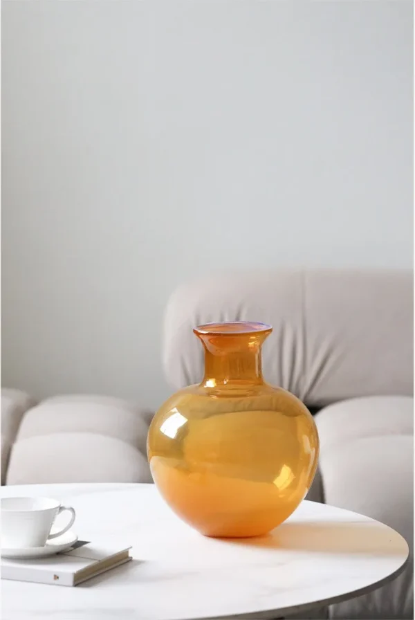 Glossy Coloured Glass Bottle Vases in Amber and Grass Green — in a room setting