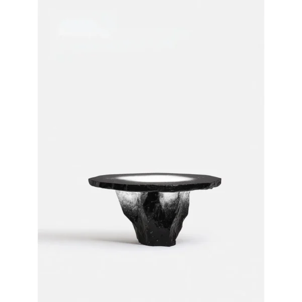 Lava Round Table with Rock-Textured Base in black — in a room setting
