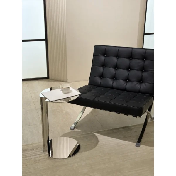 C-Shaped Mirror Steel Sofa Side Table in silver — in a room setting
