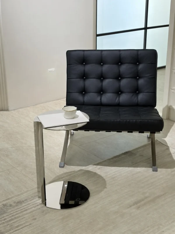 C-Shaped Mirror Steel Sofa Side Table in silver — in a room setting
