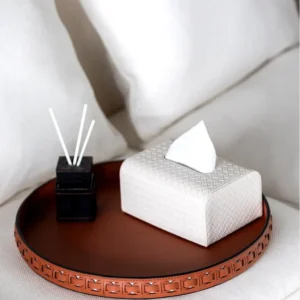 Round Black Leather Entryway Tray with Studded Rim in black — in a room setting